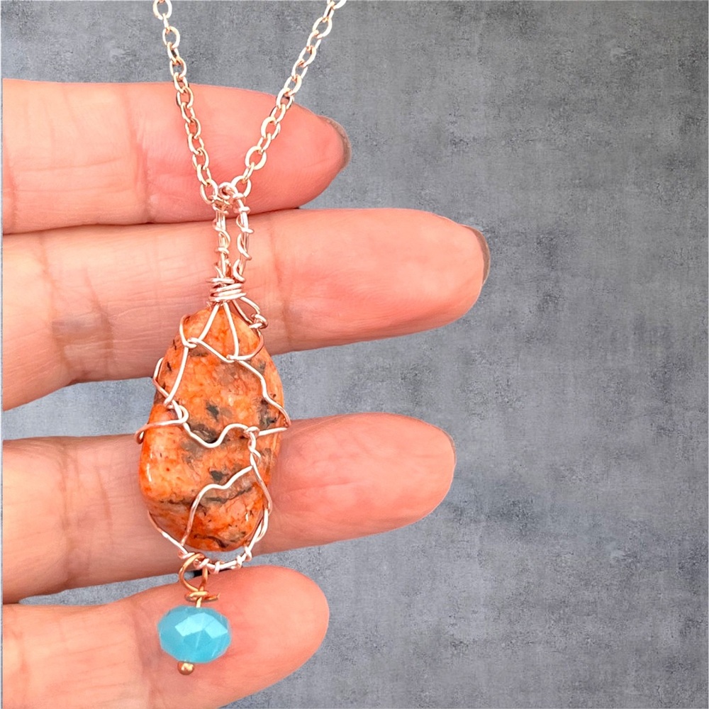 Rose gold plated natural stone pendant with a blue crystal